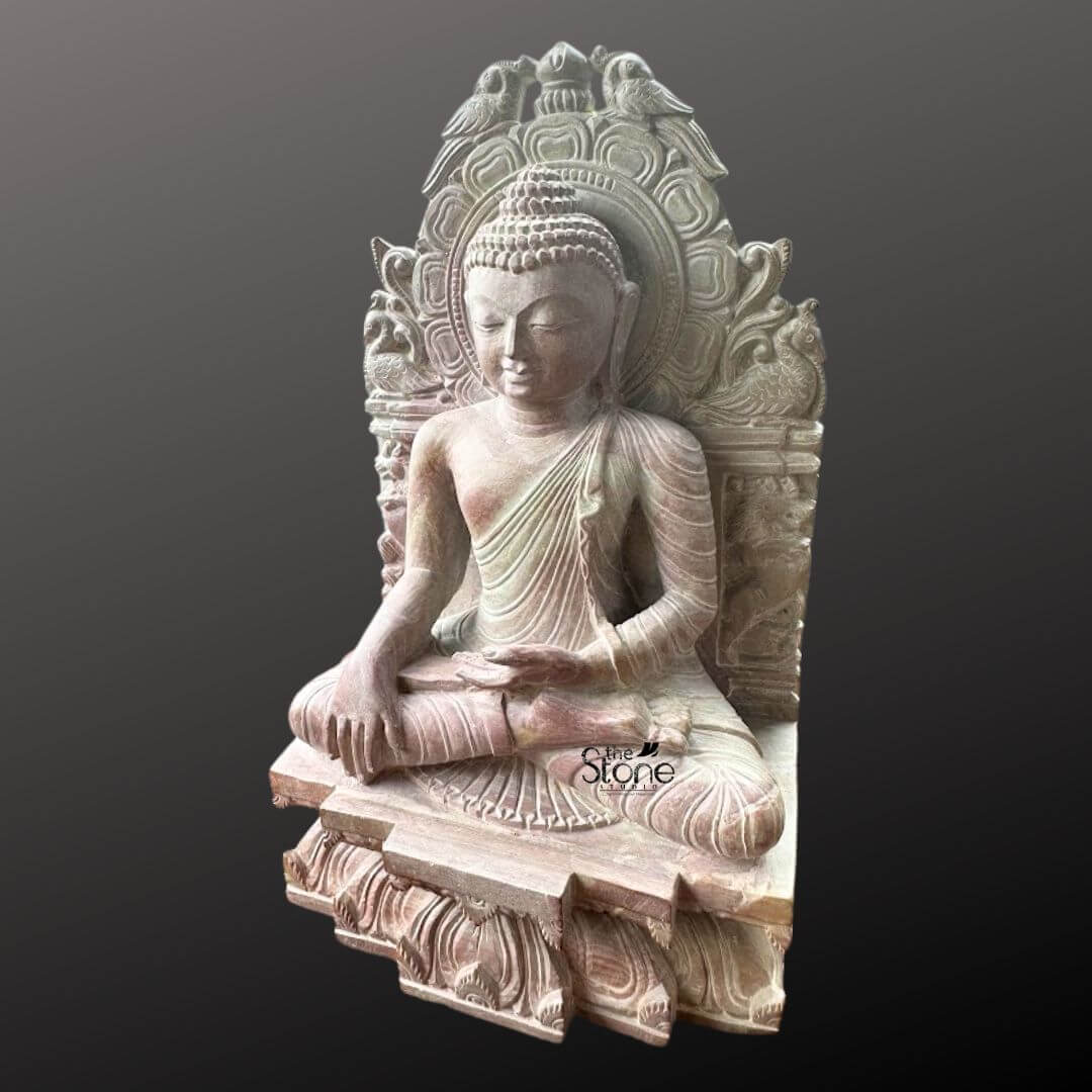 Buddha Statue 8" 4 An exquisite 8-inch Small Buddha Sculpture meticulously carved from pink stone is beautifully presented against a deep dark background making it an ideal piece for tabletop decor. The Buddha is depicted in a traditional meditative seated posture likely the Dhyana Mudra with his hands gently resting in his lap signifying profound concentration and spiritual peace. His expression is serene with downcast eyes a subtle smile and elongated earlobes all conveying deep wisdom and tranquility. The pink stone Buddha sculpture features intricate carvings particularly on the elaborate aureole or throne back that frames the deity. This backdrop is adorned with detailed motifs including birds at the top and swirling patterns adding to the idol's sacred aesthetic and artistic richness. The Buddha's hair is meticulously sculpted in tight curls culminating in the ushnisha and his robes are rendered with delicate pleats and folds. The subtle warm pink hue of the stone adds a gentle and inviting quality to the piece making it visually appealing. The statue sits on a multi-tiered base also carved with intricate patterns and what appear to be lotus petal designs suitable for stable placement on any flat surface. This 8-inch pink stone Buddha sculpture is a perfect subject for an article on small Buddha sculptures for tabletop decor. Its compact size combined with its profound artistic and spiritual value makes it an ideal choice for enhancing any interior space such as a desk shelf or bedside table. The detailed craftsmanship serene posture and calming presence make it a significant piece for fostering peace mindfulness and positive energy in a home or office environment.