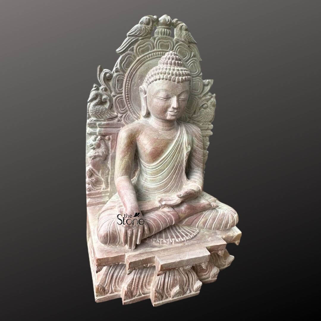 Buddha Statue 8" 7 An exquisite 8-inch Small-Size Buddha Idol meticulously carved from pink stone is beautifully presented against a deep dark background. The Buddha is depicted in a traditional meditative seated posture likely the Dhyana Mudra with his hands gently resting in his lap signifying profound concentration and spiritual peace. His expression is serene with downcast eyes a subtle smile and elongated earlobes all conveying deep wisdom and tranquility. The pink stone Buddha idol features intricate carvings particularly on the elaborate aureole or throne back that frames the deity. This backdrop is adorned with detailed motifs including birds at the top and swirling patterns adding to the idol's sacred aesthetic and artistic richness. The Buddha's hair is meticulously sculpted in tight curls culminating in the ushnisha and his robes are rendered with delicate pleats and folds. The subtle warm pink hue of the stone adds a gentle and inviting quality to the piece making it visually appealing. The idol sits on a multi-tiered base also carved with intricate patterns and what appear to be lotus petal designs providing a stable and ornate foundation. This 8-inch pink stone Buddha idol is a perfect subject for an article on small-sized Buddha idols highlighting its suitability for personal altars meditation corners or decorative shelves. Its compact size combined with its profound artistic and spiritual value makes it an ideal choice for enhancing any interior space. The detailed craftsmanship serene posture and calming presence make it a significant piece for fostering peace mindfulness and positive energy in a home or office environment.