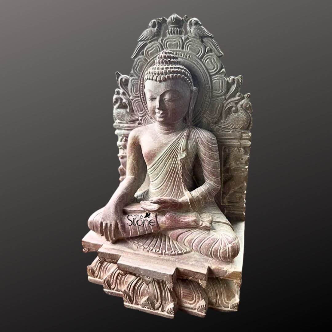 Buddha Statue 8" 5 An exquisite 8-inch Small Size Lord Buddha Statue meticulously carved from pink stone is beautifully presented against a deep dark background. The Buddha is depicted in a traditional meditative seated posture likely the Dhyana Mudra with his hands gently resting in his lap signifying profound concentration and spiritual peace. His expression is serene with downcast eyes a subtle smile and elongated earlobes all conveying deep wisdom and tranquility. The pink stone Buddha statue features intricate carvings particularly on the elaborate aureole or throne back that frames the deity. This backdrop is adorned with detailed motifs including birds at the top and swirling patterns adding to the idol's sacred aesthetic and artistic richness. The Buddha's hair is meticulously sculpted in tight curls culminating in the ushnisha and his robes are rendered with delicate pleats and folds. The subtle warm pink hue of the stone adds a gentle and inviting quality to the piece making it visually appealing. The statue sits on a multi-tiered base also carved with intricate patterns and what appear to be lotus petal designs providing a stable and ornate foundation. This 8-inch pink stone Lord Buddha statue is a perfect subject for an article on small-sized Buddha statues highlighting its suitability for personal altars meditation corners or decorative shelves. Its compact size combined with its profound artistic and spiritual value makes it an ideal choice for enhancing any interior space. The detailed craftsmanship serene posture and calming presence make it a significant piece for fostering peace mindfulness and positive energy in a home or office environment.