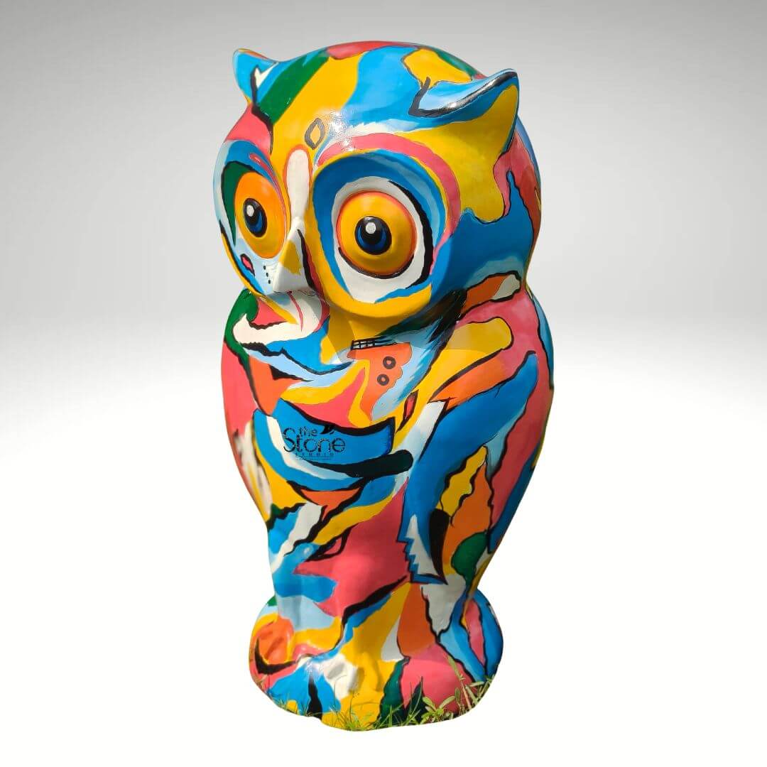 Pop Art Owl Statue 3ft 4 A vibrant hand-painted fibre Pop Art owl statue stands centered against a seamless light grey studio background. This striking sculpture measuring 36 inches in height is a dynamic kaleidoscope of bold abstract patterns and vivid colors. The entire surface is covered in a lively mix of hot pink turquoise blue bright yellow orange green and white applied in an energetic non-representational style that transforms the owl's form into a canvas for expressive art. The paintwork is characterized by sweeping brushstrokes and overlapping color blocks giving the piece a unique hand-crafted feel. The statue is sculpted in a realistic standing owl pose complete with defined ear tufts and large prominent eyes that are integrated into the abstract design. The eyes feature orange irises and dark pupils outlined in white providing an engaging slightly whimsical gaze. The textured fibre material of the statue is visible beneath the rich layers of paint adding a tactile quality to the artwork. The abstract pattern wraps fluidly around the owl's body suggesting feathers and form without being strictly illustrative. This 36-inch Fibre Pop Art Owl statue is designed to be a commanding presence and a perfect decorative element for both indoor and outdoor spaces. As a hand-painted owl statue its large scale and riot of colors make it an ideal focal point for a garden patio or living area. The Pop Art aesthetic with its bold use of commercial colors and graphic forms ensures this piece is a conversation starter. The sturdy fibre construction makes it suitable for outdoor display bringing a touch of artistic flair and color to any environment.
