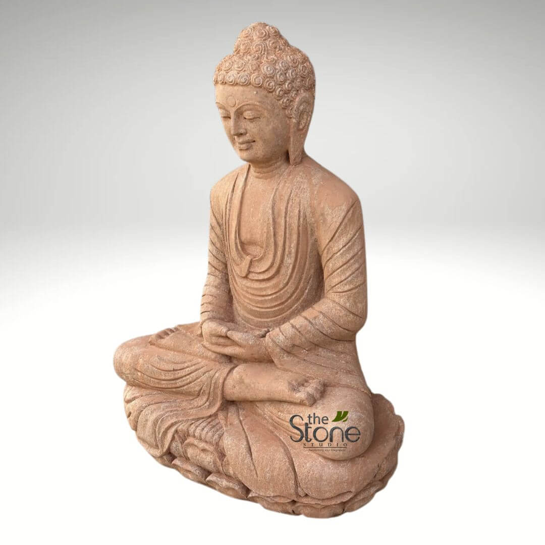 30 inches Garden Buddha Statue 3 detailed, large Buddha statue, likely crafted from natural sandstone or a high-quality concrete mix with a weathered, earthy terracotta or reddish-brown finish, stands prominently against a clean, minimalist light gray background. The Buddha is depicted seated serenely in the full lotus position (Padmasana), with hands resting gracefully in the Dhyana Mudra (meditation gesture), where the right hand rests on top of the left, palms upward, and thumbs gently touch. Gautama Buddha's face conveys profound peace, tranquility, and inner contemplation, with eyes gently downcast and a subtle, serene smile. Visible features include elongated earlobes and the ushnisha, the cranial bump symbolizing wisdom, rendered with meticulously sculpted, tightly curled hair. Flowing robes are draped naturally, showcasing detailed folds and texture that enhance the statue's realistic and artistic quality. The statue rests upon a meticulously carved double-lotus pedestal, emphasizing its spiritual significance and traditional Buddhist iconography. In the lower right corner, the logo "the Stone STUDIO" is visible, suggesting this exquisite piece is an artisanal product from a specialist in stone sculptures or garden art. This versatile Buddha statue, radiating a sense of calm and mindfulness, would be an ideal centerpiece for creating a serene outdoor garden sanctuary, a peaceful indoor meditation space, or as a distinctive element in home decor, reflecting themes of spiritual serenity, timeless design, and natural craftsmanship often explored in articles about creating harmonious environments or unique stone art.