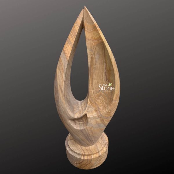 An elegant, hand-carved abstract sandstone garden sculpture made from premium natural rainbow sandstone. The sculpture features a sleek, vertical flame or teardrop-shaped silhouette with a large, hollowed-out central oval that creates a sense of openness and light. The polished surface of the rainbow sandstone highlights the stunning, multi-colored natural sediment layers, displaying wavy patterns in earthy shades of beige, tan, ochre, and chocolate brown. This modern stone statue is mounted on a sturdy, multi-tiered circular pedestal base, crafted from the same high-quality material. Designed to be a sophisticated focal point for high-end outdoor landscapes, this abstract art piece combines the raw beauty of geological formations with a contemporary minimalist aesthetic. Its durable and weather-resistant properties make it an ideal choice for garden art, bringing a touch of timeless elegance and organic texture to any courtyard, patio, or backyard sanctuary.