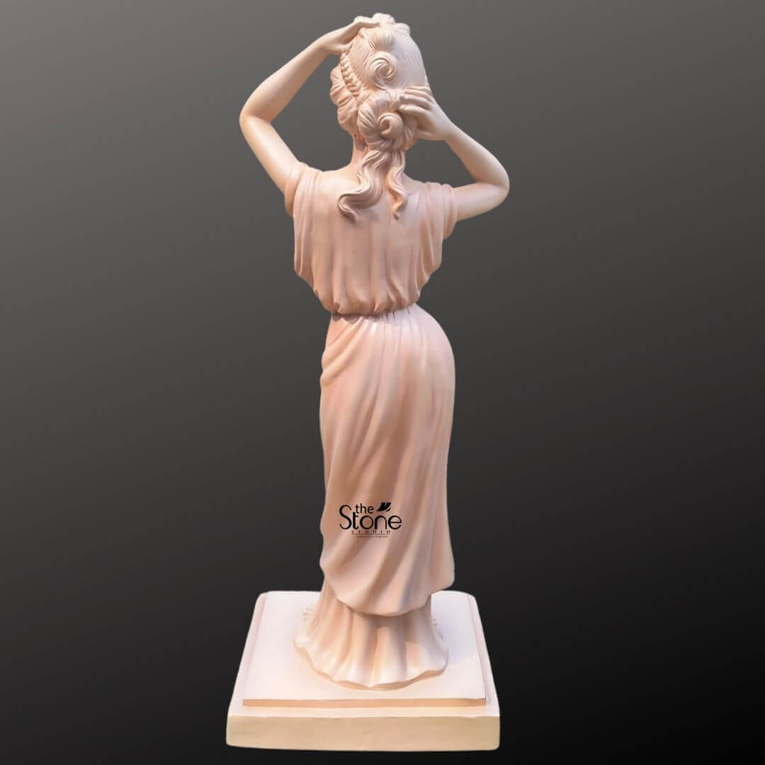 Angel Lady Statue for Resorts 5.5 Feet 7 A rear view of an elegant 5.5-foot graceful angel statue, intricately hand-carved from durable high-quality fibre. This life-sized sculpture is designed as a sophisticated centerpiece for grand gardens and luxury resorts. The figure's hair is beautifully up-styled in complex, flowing curls and delicate braids, with her arms raised in a natural, poised gesture. She is dressed in a floor-length classical gown with masterfully sculpted drapery that cascades down to the base in deep, realistic folds, suggesting a soft, cloth-like texture. The statue features a smooth, light terracotta-toned finish and stands securely on a square, tiered pedestal. At 5.5 ft tall, this lightweight and weather-resistant fibre sculpture offers a timeless aesthetic, making it an ideal choice for hotel lobbies or upscale outdoor garden sanctuaries.