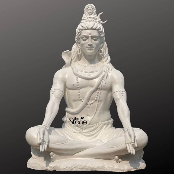 A magnificent 6-foot tall Lord Shiva fibre statue depicted in a classic meditative posture, perfect as a spiritual centerpiece for large home gardens, temples, or meditation centers. This pure white, large-scale sculpture captures the deity in a state of deep tranquility, seated in Padmasana (lotus position) with his hands resting gracefully on his knees in the Gyan Mudra. The statue features intricate traditional iconography, including the crescent moon nestled in his matted hair, the Goddess Ganga emerging from his locks, and a sacred serpent coiled around his neck. Detailed Rudraksha malas and armlets further enhance the divine aesthetic of the piece. Crafted from premium, lightweight, and durable fibre material, this Shiva idol offers the majestic appearance of polished white marble while being weather-resistant and easy to maintain, making it an ideal choice for both indoor and outdoor spiritual landscapes.