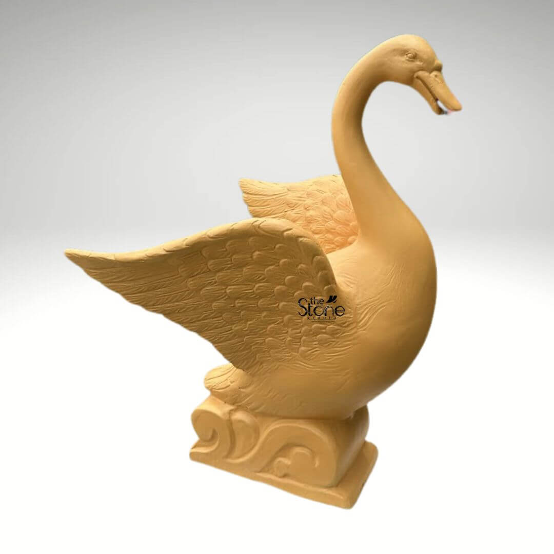 Garden Duck Fountain 2ft 7 An exquisite 2-foot tall elegant duck water fountain, masterfully crafted from durable and lightweight fibre material, designed as a sophisticated spiritual and aesthetic centerpiece for a lawn or garden. The sculpture depicts a majestic swan-style bird in a dynamic pose with its wings fully spread, showcasing intricate, rhythmic feather textures etched into the surface. Its long, slender neck is gracefully arched, adding a sense of lifelike movement and grace. The bird is mounted on an artistic pedestal base embellished with traditional wave-like relief carvings, emphasizing its connection to outdoor water features. This weather-resistant fibre water fountain serves as a perfect artistic focal point for outdoor courtyards, pond areas, or contemporary lawns, inviting tranquility and organic beauty into the home’s exterior sanctuary.