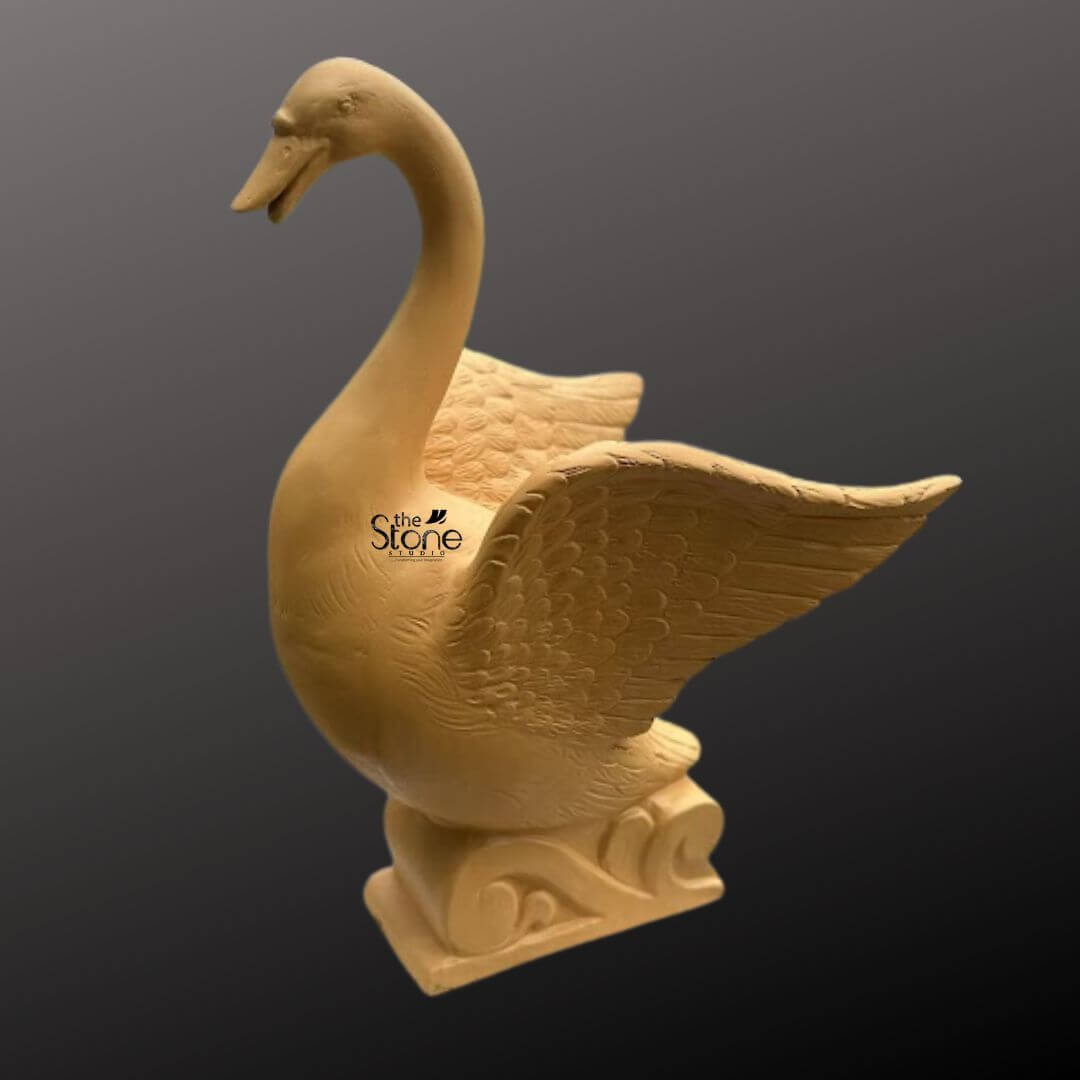 Garden Duck Fountain 2ft 9 An elegant 2-foot tall outdoor duck fountain, masterfully crafted from durable and lightweight fibre material, designed as a sophisticated spiritual and aesthetic centerpiece for a garden or landscape. The sculpture depicts a majestic swan-style bird in a dynamic pose with its wings fully spread, showcasing intricate, rhythmic feather textures etched into the surface. Its long, slender neck is gracefully arched, adding a sense of lifelike movement and grace. The bird is mounted on an artistic pedestal base embellished with traditional wave-like relief carvings, emphasizing its connection to outdoor water features. This weather-resistant fibre water fountain serves as a perfect artistic focal point for outdoor courtyards, pond areas, or contemporary lawns, inviting tranquility and organic beauty into the home’s exterior sanctuary.