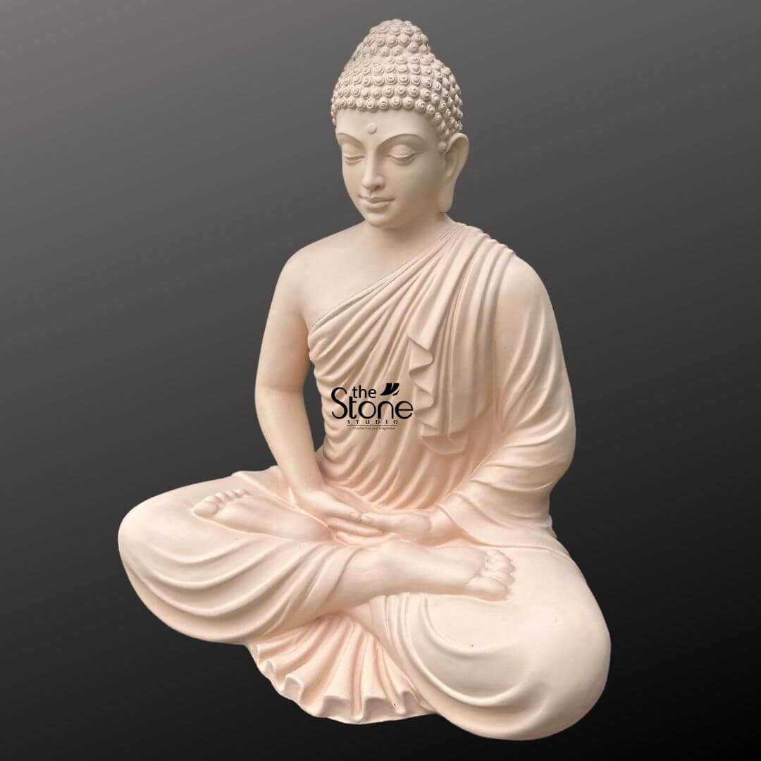 Buddha Statue for Home Decor 4 Feet 9 A majestic 4-foot tall Lord Buddha fibre statue depicted in a traditional seated meditative pose serves as a serene centerpiece for a peaceful home or spiritual sanctuary. The sculpture captures the Buddha in deep contemplation with his eyes gently closed and a tranquil facial expression that radiates inner calm and wisdom. The idol is finished in an elegant light ivory tone, providing a smooth stone-like appearance while offering the durability and lightweight quality of high-grade fibre material. Lord Buddha’s hands are positioned in the Dhyana Mudra resting calmly in his lap to symbolize absolute balance and tranquility. The monastic robes are meticulously detailed with realistic fluidly carved fabric folds draped gracefully over the left shoulder. With its substantial 4-foot scale and aura of stillness this meditation Buddha idol is an ideal addition to a home mandir, contemporary living room, or dedicated meditation space. Its timeless design and traditional Vedic iconography are specifically crafted to ground the environment and inspire a state of mindfulness and peace within any domestic landscape.