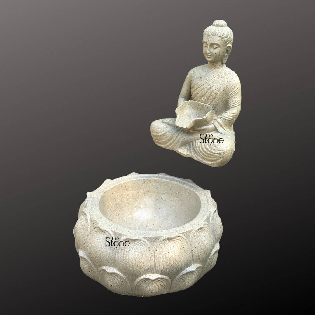 Wall-Mounted Buddha Fountain 3ft 2 A serene Fibre Buddha fountain, designed for wall mounting is elegantly presented against a dark minimalist background emphasizing its peaceful aesthetic and functional design. The fountain features a tranquil Buddha figure sculpted from light-colored fiber with a slightly textured stone-like finish seated in the lotus position. The Buddha's hands are gently positioned in his lap holding a small shallow bowl from which water is intended to flow. His eyes are downcast conveying a profound sense of meditation inner peace and spiritual contemplation making it an ideal focal point for a calming environment. The Buddha statue is depicted with smooth flowing robes draped gracefully over his body with naturalistic folds that add depth and realism to the lightweight fiber material. His facial features are serene and finely sculpted featuring a ushnisha on his head symbolizing wisdom and enlightenment and elongated earlobes indicative of his renunciation of worldly possessions. The light neutral color of the fiber lends the statue a timeless and versatile appeal suitable for various decor styles. Positioned directly beneath the Buddha figure and appearing as if mounted on the same wall plane, is a large intricately carved lotus-shaped basin. This basin, matching the light-colored textured finish of the Buddha, features multiple layers of detailed lotus petals symbolizing purity, spiritual awakening, and beauty. The design clearly indicates that water would gently cascade from the Buddha's bowl into this larger aesthetically pleasing basin, creating a soothing sound and visual effect. This fiber Buddha fountain is an ideal piece for creating a calming and meditative atmosphere in a garden, patio or indoor spiritual space as highlighted in an article discussing wall-mounted Buddha fountains.