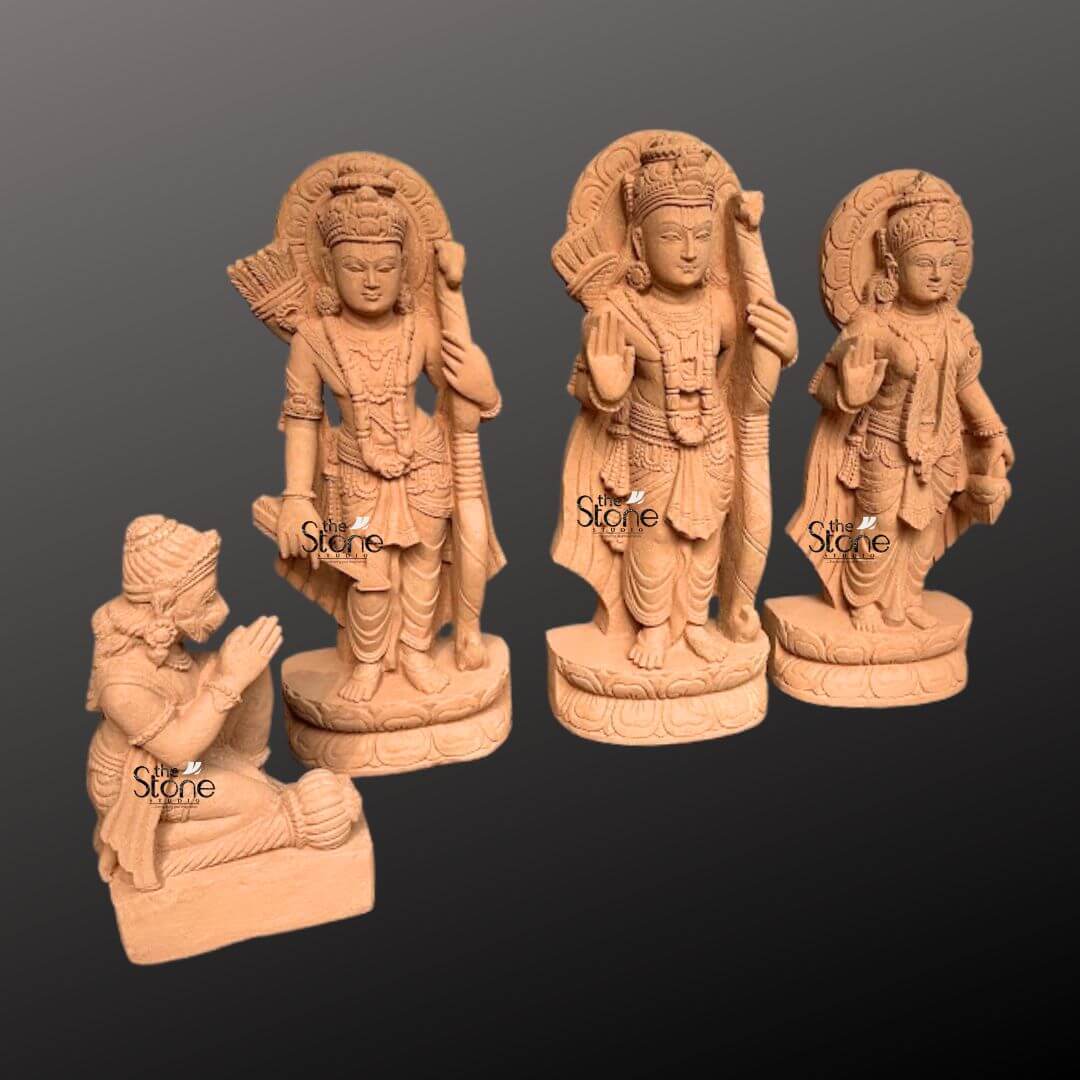 Ram Darbar Idol for Home Temple 2ft 2 A beautifully sculpted 2-foot sandstone Lord Ram Darbar statue set is elegantly displayed against a dark gradient background. The set comprises four figures: Lord Rama Lakshmana Sita and a kneeling Hanuman representing a revered divine assembly. Lord Rama stands prominently in the center, holding his bow and arrow embodying righteousness and valor. To his left stands Lakshmana also armed and to his right the graceful Sita, radiating purity and devotion with her hand raised in a gesture of blessing. Each of these standing figures is adorned with elaborate crowns intricate jewelry and flowing traditional garments all meticulously carved from the warm earthy sandstone. Behind the heads of Rama, Lakshmana and Sita circular halo-like structures are intricately carved with traditional patterns further accentuating their divine aura and spiritual significance. The craftsmanship is evident in every detail from the serene expressions on their faces to the delicate folds of their attire and the intricate patterns of their ornaments. The sandstone's natural texture and warm hue give the statues an authentic ancient feel enriching their spiritual presence and highlighting the artisans' skill. In the foreground, kneeling respectfully is Hanuman carved in a posture of profound devotion with his hands clasped in reverence. The standing figures each rest on multi-layered circular bases featuring delicate lotus petal motifs. This complete 2-foot sandstone Lord Ram Darbar set captures the essence of this beloved divine assembly representing loyalty devotion and divine love. Its harmonious composition and exquisite detailing make this a captivating subject for an article exploring Lord Ram Darbar statues and their importance in Hindu tradition.