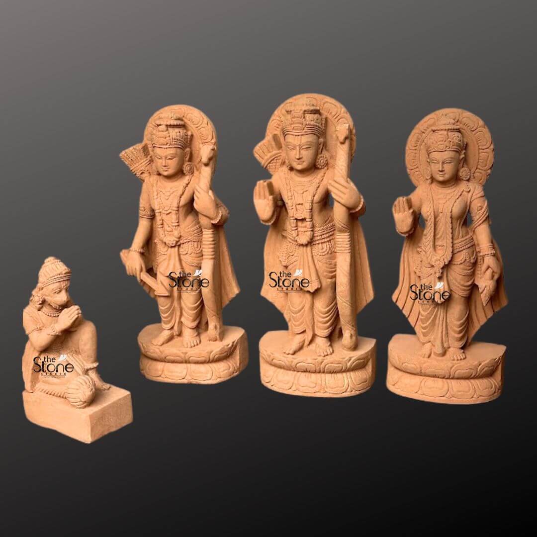 Ram Darbar Idol for Home Temple 2ft 4 A beautifully sculpted 2-foot sandstone Ram Darbar Murti set is elegantly displayed against a dark gradient background making it a revered centerpiece for any home. The set comprises four figures: Lord Rama Lakshmana Sita and a kneeling Hanuman collectively forming a revered divine assembly. Lord Rama stands prominently in the center holding his bow and arrow embodying righteousness and valor. To his left stands Lakshmana also armed and to his right the graceful Sita radiating purity and devotion with her hand raised in a gesture of blessing. Each of these standing figures is adorned with elaborate crowns intricate jewelry and flowing traditional garments all meticulously carved from the warm earthy sandstone. Behind the heads of Rama Lakshmana, and Sita circular halo-like structures are intricately carved with traditional patterns further accentuating their divine aura and spiritual significance within a home setting. The craftsmanship is evident in every detail from the serene expressions on their faces to the delicate folds of their attire and the intricate patterns of their ornaments. The sandstone's natural texture and warm hue give the statues an authentic, ancient feel enriching their spiritual presence and highlighting the artisans' skill, making them visually appealing for home decor. In the foreground kneeling respectfully is Hanuman carved in a posture of profound devotion with his hands clasped in reverence. The standing figures each rest on multi-layered circular bases featuring delicate lotus petal motifs providing both stability and aesthetic appeal. This complete 2-foot sandstone Ram Darbar Murti set captures the essence of this beloved divine assembly representing loyalty devotion, and divine love, and serves as a captivating subject for an article exploring Ram Darbar Murtis and their importance for spiritual enhancement in homes.