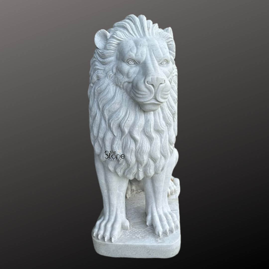 White Marble Lion Statue 5ft 9 A majestic white marble lion statue is prominently displayed against a dark gradient background embodying strength and regal elegance making it an ideal choice for outdoor decor. The lion is sculpted in a powerful seated position with its front paws extended forward and its robust body held upright. Its head is turned slightly featuring a detailed fierce yet noble expression with deep-set eyes a strong muzzle and a commanding gaze giving it a watchful demeanor suitable for an outdoor guardian. The intricate carving brilliantly highlights the texture of its voluminous flowing mane which cascades around its head and shoulders conveying a sense of immense power and majesty. The statue is crafted from pristine white marble which exquisitely emphasizes the fine details of the carving, from the individual strands within the mane to the strong definition of its musculature and the sharp claws on its paws. The smooth polished surface of the marble subtly reflects light accentuating the contours of the lion's formidable form. The inherent beauty and purity of the white marble are showcased underlining the artisan's skill in transforming raw stone into such a lifelike and commanding figure that would stand out gracefully amidst any outdoor landscape. The white marble lion statue rests on a sturdy rectangular base also carved from matching white marble providing a solid foundation that integrates seamlessly with the overall design. This elegant sculpture captures the essence of a powerful guardian and a timeless symbol of royalty and strength making it a captivating subject for an article exploring white lion statues and their commanding presence when used for enhancing outdoor decor in gardens patios, or entrances.