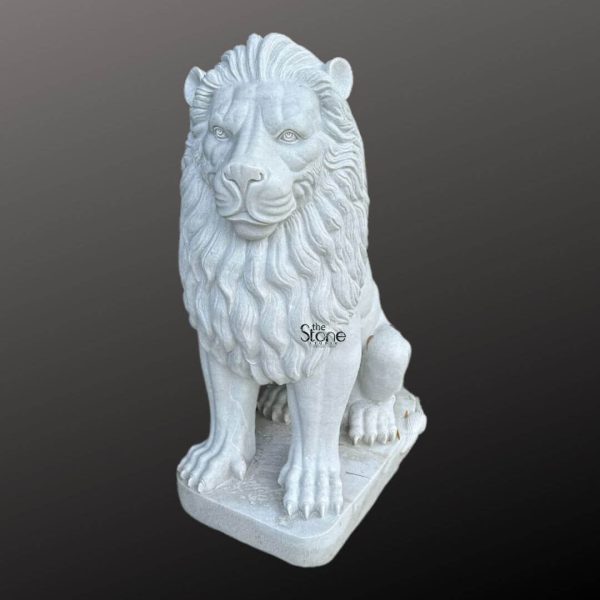 A majestic white marble lion statue is prominently displayed against a dark gradient background embodying strength and regal elegance. The lion is sculpted in a seated position with its front paws extended forward and its powerful body held upright. Its head is turned slightly featuring a detailed fierce yet noble expression with deep set eyes and a strong muzzle. The intricate carving highlights the texture of its flowing mane which cascades around its head and shoulders giving it a voluminous and majestic appearance. The statue is crafted from pristine white marble which emphasizes the fine details of the carving from the individual strands within the mane to the sharp claws on its paws. The smooth polished surface of the marble reflects light subtly accentuating the contours and musculature of the lion's form. The natural veining of the marble if any would add unique character to this handcrafted piece showcasing the beauty and purity of the stone. The white marble lion statue rests on a sturdy rectangular base also carved from matching white marble providing a solid foundation and integrating seamlessly with the overall design. This elegant sculpture captures the essence of a powerful guardian making it a captivating subject for an article exploring white marble lion statues their symbolism and their use in grand architectural or decorative settings.