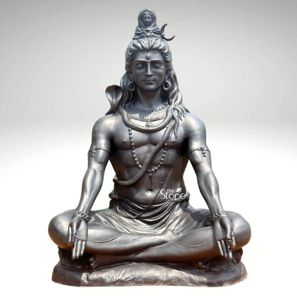 A magnificent 6-foot meditating Lord Shiva statue crafted from fiber and finished to resemble antique metal is presented against a clean light background emphasizing its grandeur and spiritual presence. The statue depicts Lord Shiva in a classic meditative posture exuding an aura of profound tranquility cosmic power and divine wisdom. This large-scale fiber Shiva statue is an impressive and inspiring piece ideal for a prominent display in a temple meditation center or a spacious garden. Lord Shiva's features are sculpted with remarkable detail and serenity: his eyes are half-closed in deep contemplation his long, flowing hair is piled high adorned with a crescent moon and a miniature figure of Goddess Ganga symbolizing the sacred river's descent. A cobra gracefully coils around his neck and multiple rudraksha bead malas drape across his chest and torso. His hands rest gently in his lap in Dhyana Mudra the gesture of meditation while his muscular yet serene physique is subtly defined beneath his draped lower garment. The metallic finish of the fiber material gives it a substantial and timeless appearance. This 6-foot meditating Lord Shiva statue is a powerful representation of the ultimate reality the destroyer of evil and the source of all yoga and meditation. The exceptional craftsmanship in fiber allows for intricate detailing and a commanding presence making it a visually striking and spiritually significant artifact. This statue not only serves as a focal point for devotion and meditation but also as a majestic piece of art that radiates peace strength, and cosmic energy enriching any space with its profound cultural and religious resonance.