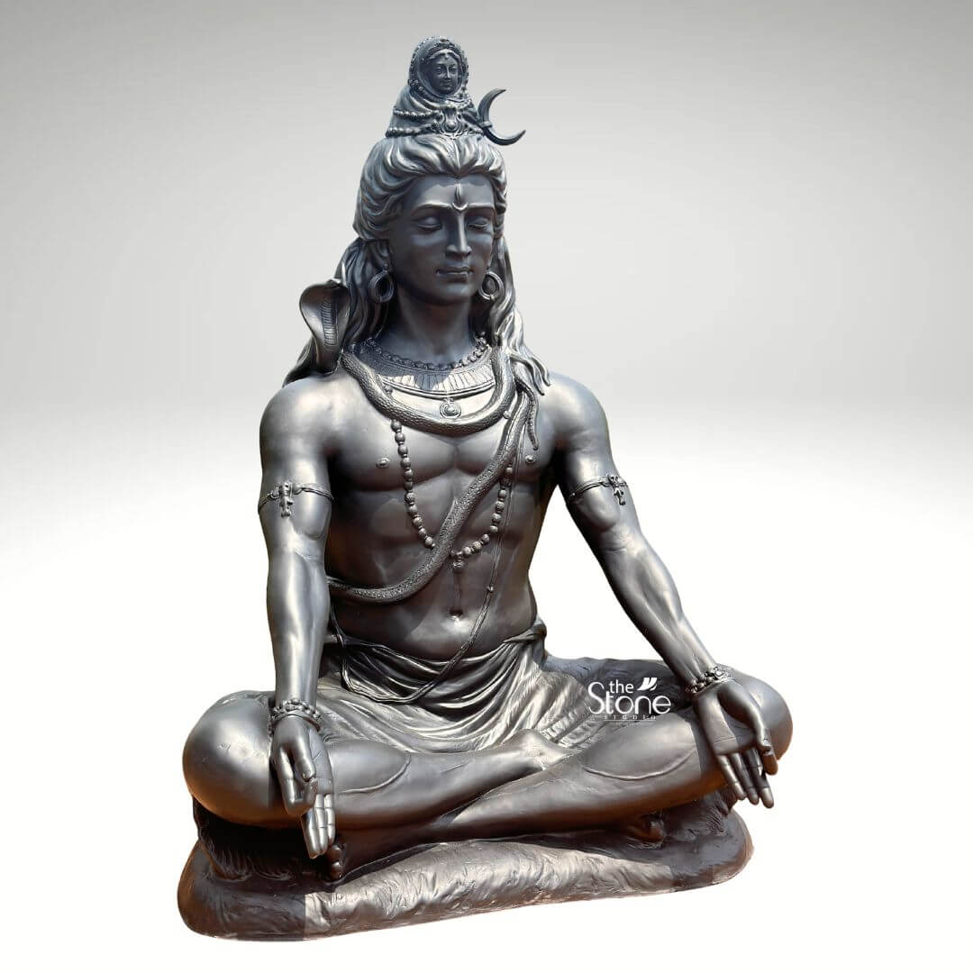 6 Feet Meditating Lord Shiva Statue 2 A magnificent 6-foot sitting Lord Shiva statue crafted from fiber and finished to resemble antique metal is presented against a clean light background emphasizing its grandeur and spiritual presence. The statue depicts Lord Shiva in a classic meditative posture exuding an aura of profound tranquility cosmic power and divine wisdom. This large-scale fiber Shiva statue is an impressive and inspiring piece ideal for a prominent display in a temple meditation center or a spacious garden. Lord Shiva's features are sculpted with remarkable detail and serenity: his eyes are half-closed in deep contemplation his long, flowing hair is piled high adorned with a crescent moon and a miniature figure of Goddess Ganga symbolizing the sacred river's descent. A cobra gracefully coils around his neck and multiple rudraksha bead malas drape across his chest and torso. His hands rest gently in his lap in Dhyana Mudra the gesture of meditation while his muscular yet serene physique is subtly defined beneath his draped lower garment. The metallic finish of the fiber material gives it a substantial and timeless appearance with subtle variations in tone highlighting the sculptural forms. This 6-foot sitting Lord Shiva statue is a powerful representation of the ultimate reality the destroyer of evil and the source of all yoga and meditation. The exceptional craftsmanship in fiber allows for intricate detailing and a commanding presence making it a visually striking and spiritually significant artifact. This statue not only serves as a focal point for devotion and meditation but also as a majestic piece of art that radiates peace strength and cosmic energy enriching any space with its profound cultural and religious resonance.