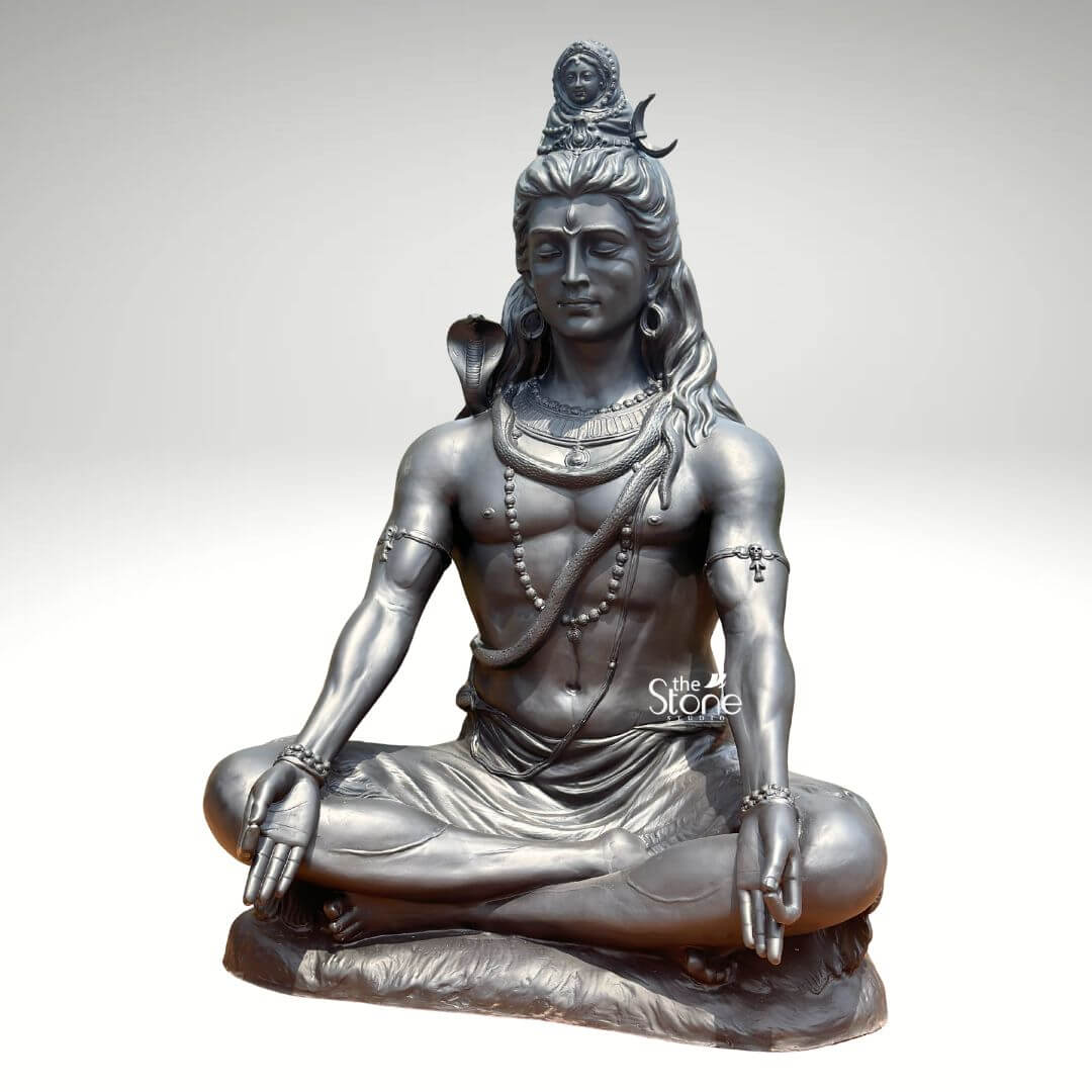 6 Feet Meditating Lord Shiva Statue 4 A magnificent 6-foot Lord Shiva Dhyan Murti crafted from fiber and finished to resemble antique metal is presented against a clean light background emphasizing its grandeur and spiritual presence. The statue depicts Lord Shiva in a classic meditative posture exuding an aura of profound tranquility cosmic power and divine wisdom. This large-scale fiber Shiva statue is an impressive and inspiring piece ideal for a prominent display in a temple meditation center or a spacious garden. Lord Shiva's features are sculpted with remarkable detail and serenity: his eyes are half-closed in deep contemplation his long flowing hair is piled high adorned with a crescent moon and a miniature figure of Goddess Ganga symbolizing the sacred river's descent. A cobra gracefully coils around his neck and multiple rudraksha bead malas drape across his chest and torso. His hands rest gently in his lap in Dhyana Mudra the gesture of meditation while his muscular yet serene physique is subtly defined beneath his draped lower garment. The metallic finish of the fiber material gives it a substantial and timeless appearance with subtle variations in tone highlighting the sculptural forms and the overall meditative poise. This 6-foot Lord Shiva Dhyan Murti is a powerful representation of the ultimate reality the destroyer of evil and the source of all yoga and meditation. The exceptional craftsmanship in fiber allows for intricate detailing and a commanding presence making it a visually striking and spiritually significant artifact. This statue not only serves as a focal point for devotion and meditation but also as a majestic piece of art that radiates peace strength and cosmic energy enriching any space with its profound cultural and religious resonance.