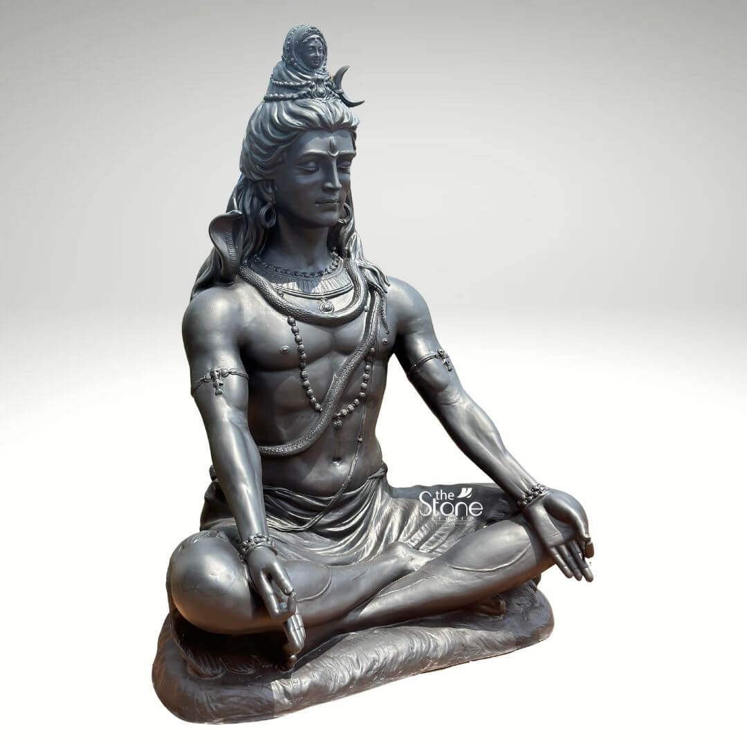 6 Feet Meditating Lord Shiva Statue 5 A magnificent 6-foot Mahadev Meditation Statue crafted from fiber and finished to resemble antique metal is presented against a clean light background emphasizing its grandeur and spiritual presence. The statue depicts Lord Shiva in a classic meditative posture exuding an aura of profound tranquility cosmic power and divine wisdom. This large-scale fiber Shiva statue is an impressive and inspiring piece ideal for a prominent display in a temple meditation center or a spacious garden. Lord Shiva's features are sculpted with remarkable detail and serenity his eyes are half-closed in deep contemplation his long flowing hair is piled high adorned with a crescent moon and a miniature figure of Goddess Ganga symbolizing the sacred river's descent. A cobra gracefully coils around his neck and multiple rudraksha bead malas drape across his chest and torso. His hands rest gently in his lap in Dhyana Mudra the gesture of meditation while his muscular yet serene physique is subtly defined beneath his draped lower garment. The metallic finish of the fiber material gives it a substantial and timeless appearance with subtle variations in tone highlighting the sculptural forms and the overall meditative poise. This 6-foot Mahadev Meditation Statue is a powerful representation of the ultimate reality the destroyer of evil and the source of all yoga and meditation. The exceptional craftsmanship in fiber allows for intricate detailing and a commanding presence making it a visually striking and spiritually significant artifact. This statue not only serves as a focal point for devotion and meditation but also as a majestic piece of art that radiates peace strength and cosmic energy enriching any space with its profound cultural and religious resonance truly embodying the meditative aspect of Mahadev.