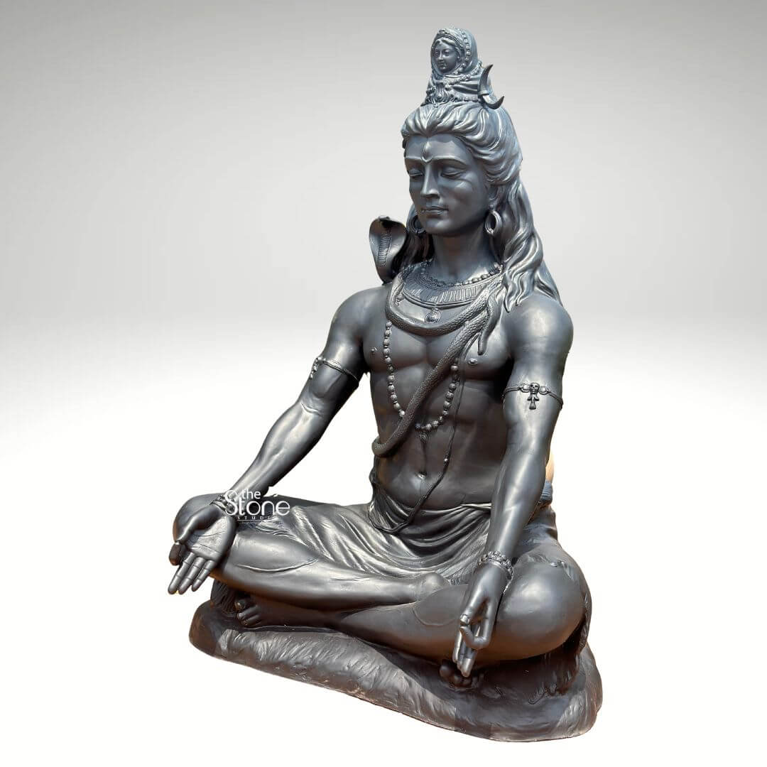 6 Feet Meditating Lord Shiva Statue 6 A magnificent 6-foot Fibre Meditating Mahadev Statue finished to resemble antique metal is presented against a clean light background emphasizing its grandeur and spiritual presence. The statue depicts Lord Shiva in a classic meditative posture exuding an aura of profound tranquility cosmic power and divine wisdom. This large-scale fiber Shiva statue is an impressive and inspiring piece ideal for a prominent display in a temple meditation center or a spacious garden. Lord Shiva's features are sculpted with remarkable detail and serenity: his eyes are half-closed in deep contemplation his long flowing hair is piled high adorned with a crescent moon and a miniature figure of Goddess Ganga symbolizing the sacred river's descent. A cobra gracefully coils around his neck and multiple rudraksha bead malas drape across his chest and torso. His hands rest gently in his lap in Dhyana Mudra the gesture of meditation while his muscular yet serene physique is subtly defined beneath his draped lower garment. The metallic finish of the fiber material gives it a substantial and timeless appearance with subtle variations in tone highlighting the sculptural forms and the overall meditative poise enhancing its realistic appeal. This 6-foot Fibre Meditating Mahadev Statue is a powerful representation of the ultimate reality the destroyer of evil, and the source of all yoga and meditation. The exceptional craftsmanship in fiber allows for intricate detailing and a commanding presence making it a visually striking and spiritually significant artifact. This statue not only serves as a focal point for devotion and meditation but also as a majestic piece of art that radiates peace strength and cosmic energy, enriching any space with its profound cultural and religious resonance truly embodying the meditative aspect of Mahadev.