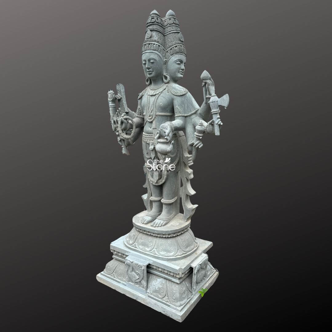 Brahma Stone Statue 7ft 2 A magnificent 7-foot Greystone Brahma Statue is presented in a stately slightly oblique front view against a dark plain background emphasizing its grandeur and intricate craftsmanship. The statue depicts Lord Brahma the creator god in a standing posture with his characteristic four heads symbolizing his omnipresence and knowledge of the four Vedas. The natural grey tones and subtle textures of the stone lend an ancient and dignified quality to this impressive statue highlighting its detailed carvings. Lord Brahma is meticulously carved with his four serene and contemplative faces each adorned with an elaborate crown and facing the cardinal direction. He is richly adorned with multiple necklaces armlets and a sacred thread all finely detailed. In his multiple hands he holds his traditional attributes including a sruva or rosary a kamandalu and a puskara symbolizing his role in creation and knowledge. His attire is elegantly draped with intricate patterns on his lower garment and decorative elements around his waist. He stands barefoot on a lotus pedestal which in turn rests on a multi-tiered intricately carved base featuring smaller decorative elements and possibly mythical creatures. This 7-foot greystone Brahma Statue is a profound representation of creation wisdom and cosmic knowledge making it a powerful and auspicious addition to any temple or significant spiritual space. The exceptional craftsmanship in natural greystone not only makes it a visually striking piece but also imbues it with deep cultural and religious significance. This exquisitely detailed statue serves as a commanding focal point for devotion and prayer radiating positive energy and ancient wisdom to all who venerate it.
