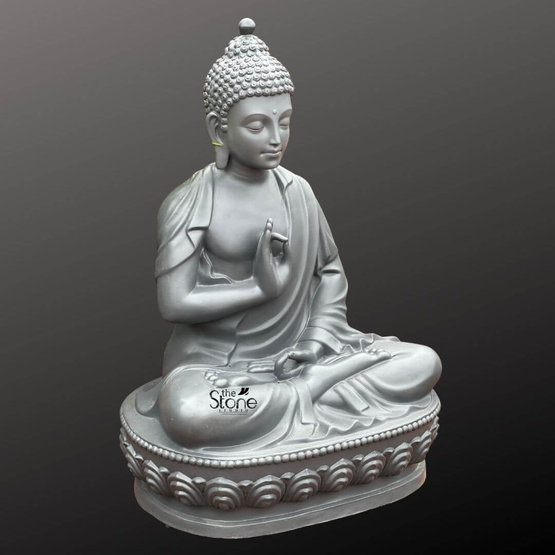 Seated Buddha Statue in Vitarka Mudra 3.5ft 4 A striking 3.5-foot Seated Buddha Statue meticulously crafted from fiber is presented at a slight angle against a deep contrasting grey background. The statue captures Buddha in a serene meditative posture seated in the full lotus position. His right hand is raised in the Vitarka Mudra the gesture of teaching and intellectual discussion with the thumb and index finger touching to form a circle while the other fingers are extended upwards. His left hand rests gently in his lap with the palm facing upwards signifying contemplation. The statue's monochromatic light grey finish provides a contemporary and elegant aesthetic highlighting the intricate contours and delicate details of the sculpture. Buddha's face radiates tranquility with eyes gently downcast in introspection a subtle serene smile gracing his lips and elongated earlobes a symbol of his renunciation of worldly possessions and princely past. His head is adorned with tightly coiled hair and the ushnisha the cranial bump signifying his supreme spiritual wisdom and enlightenment. The flowing drapery of his robes is expertly rendered with soft folds and graceful lines suggesting the texture of fabric and contributing to the statue's overall peaceful and elegant form. The fiber material allows for a smooth finish and precise detailing giving the statue a substantial yet refined appearance. The Buddha is seated upon a beautifully sculpted double-lotus pedestal with each petal intricately carved symbolizing purity spiritual awakening and divine birth. This impressive 3.5-foot Buddha Fibre statue embodying profound spiritual meaning and artistic excellence serves as a powerful representation of Buddhist philosophy and an ideal focal point for meditation spaces, gardens or as a significant cultural accent in a home or public setting. Its grand size and detailed craftsmanship make it a compelling piece for those seeking to enhance their environment with a symbol of peace wisdom and enlightenment aligning perfectly with the article's focus on Seated Buddha Statues.