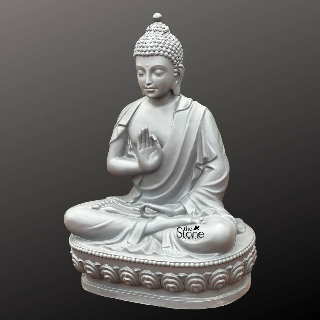 Seated Buddha Statue in Vitarka Mudra 3.5ft 5 A captivating 3.5-foot Meditating Buddha Statue crafted from fiber is prominently displayed against a uniform dark grey background offering a sense of depth and focus. The statue depicts Buddha in a classic meditative posture seated in the full lotus position symbolizing deep concentration and spiritual enlightenment. His right hand is raised in the Vitarka Mudra forming a circle with the thumb and index finger while the other fingers are extended conveying the transmission of teaching and intellectual discussion an essential aspect of meditative practice. His left hand rests gently in his lap palm upwards signifying contemplation and receptivity. The statue's consistent light grey finish provides a contemporary and elegant aesthetic allowing the subtle contours and fine details of the sculpture to be clearly appreciated. The Buddha's face is carved with exceptional artistry radiating profound peace and inner wisdom. His eyes are gently closed or downcast suggesting deep introspection and a calm state of mind ideal for a meditating figure. A subtle serene smile graces his lips, and his elongated earlobes a traditional symbol in Buddhist iconography subtly reference his detachment from worldly possessions. His head is adorned with tightly coiled hair culminating in the ushnisha the symbolic cranial protuberance that signifies his supreme spiritual knowledge and enlightenment achieved through meditation. The flowing drapery of his robes is expertly rendered with soft folds and graceful lines conveying the lightness and texture of fabric further enhancing the statue's peaceful and elegant form. The Buddha is seated upon a beautifully sculpted double-lotus pedestal with each petal intricately carved symbolizing purity spiritual growth and the emergence of enlightenment from the mundane. This 3.5-foot Buddha Fibre statue embodying profound spiritual meaning and artistic excellence is an ideal representation for a Meditating Buddha Statue for Home. Its impressive size and detailed craftsmanship make it a perfect centerpiece to inspire tranquility reflection, and a sense of calm in any indoor or outdoor living space aligning perfectly with the article's theme of bringing meditative energy into the home.
