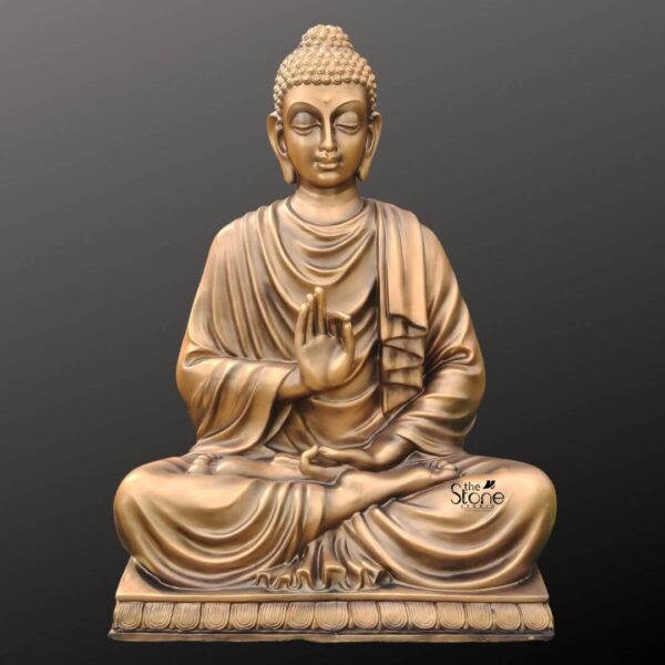 A centered eye-level photograph captures a meticulously crafted five-foot-tall Buddha statue presented against a dark neutral gradient background that emphasizes its form. The statue made of durable fibreglass is finished to look like aged antique bronze with a rich textured patina featuring variations of deep gold and subtle verdigris giving it the appearance of a heavy cast metal sculpture. Lord Buddha is depicted in a seated meditative posture upon an ornate tiered lotus throne which is also rendered in the matching antique bronze finish. His eyes are gently closed in a serene compassionate expression and his head features the traditional ushnisha and tightly curled hair. The Buddha's body is draped in flowing finely detailed monastic robes the folds of which are sculpted with great care to look naturalistic and heavy enhancing the impression of a traditional metal statue while retaining the lightweight advantages of fibreglass. His hands are held in a specific mudra the right hand is raised to chest level in the vitarka mudra with the thumb and index finger touching to form a circle while the left hand rests in his lap palm facing up in the dhyana mudra. The intricate details of the robe's texture the facial features and the lotus petal base are clearly visible under soft even studio lighting. This image serves as a prime example of a high-quality antique finish Buddha sculpture created from fibreglass. The five-foot stature makes it an imposing yet elegant piece for indoor or covered outdoor placement suitable for creating a tranquil atmosphere. The detailed carving and the convincing aged patina highlight the craftsmanship involved in producing fibreglass sculptures that mimic the aesthetic of traditional temple art. This visual representation is perfectly suited for articles discussing the benefits artistry and decorative applications of antique-finish Buddha fibre sculptures.