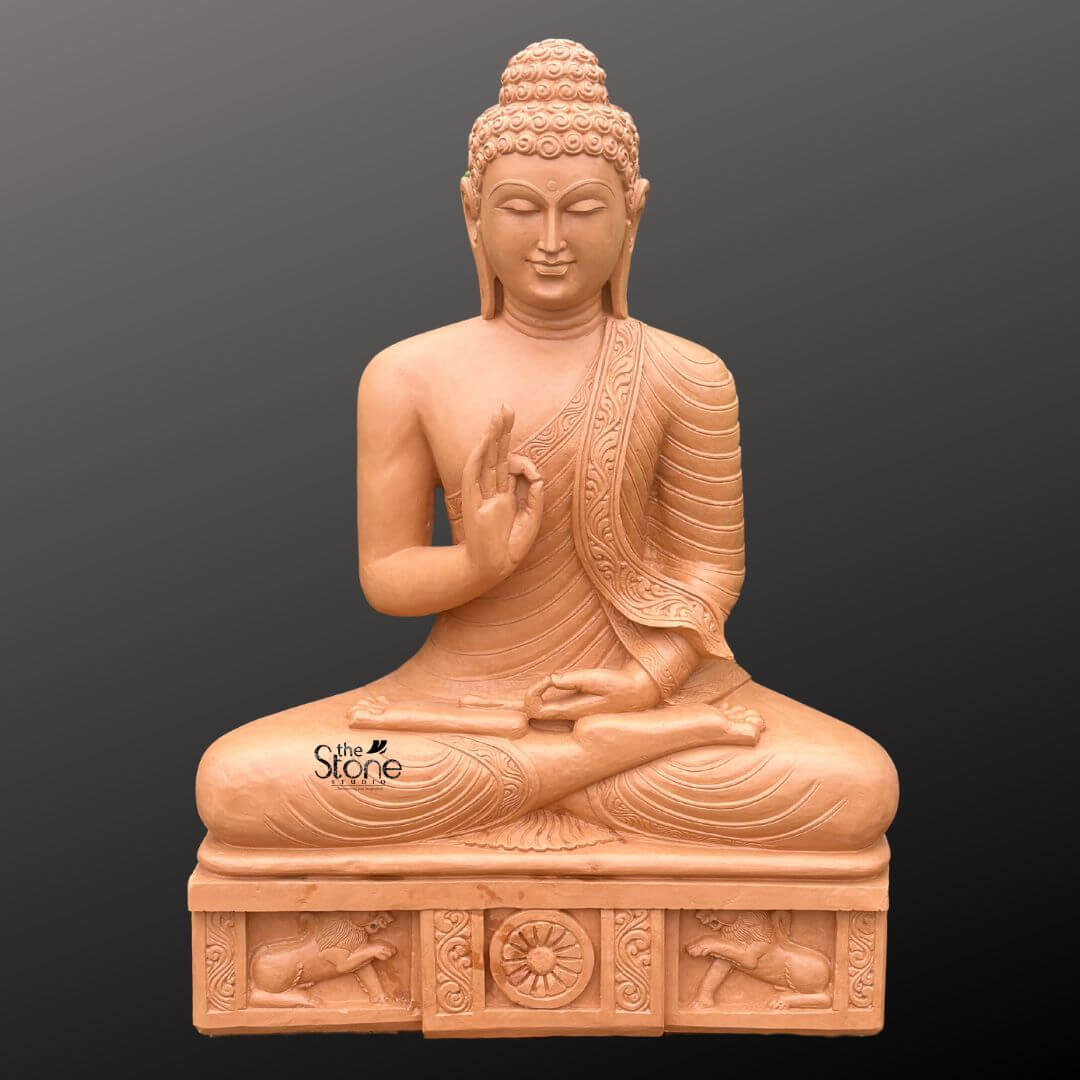 A full-view centered photograph presents a large magnificent 4-foot tall sandstone Buddha statue meticulously hand-carved and designed as an imposing focal point for a garden setting. The statue is carved from warm light-brown sandstone showcasing a natural slightly textured finish that emphasizes its artisanal quality. It is seated in the traditional vajra lotus position embodying a profound sense of peace and meditation. The figure is draped in intricately carved monastic robes with the fabric folds and a decorative patterned border clearly defined on the left shoulder. The Buddha's hands are held in the Vitarka Mudra with the right hand raised and the thumb and index finger forming a circle symbolizing the transmission of teachings while the left hand rests in his lap. The statue sits upon a substantial carved rectangular pedestal which is an integral part of the entire 4-foot structure. This pedestal is adorned with detailed bas-relief carvings on its front face. In the center is a depiction of the Dharma Chakra flanked on either side by sculpted lions ancient symbols of the Buddha's royalty and the spread of his teachings. The entire plinth adds to the statue's monumental presence and cultural authenticity. The sandstone exhibits natural color variations and a tactile weathered look that would harmonize beautifully with natural garden elements like plants stone pathways, and sunlight. This Large Stone Buddha Statue for Garden use is an exceptional piece of art that combines spiritual symbolism with grand scale. The 4-foot height ensures it will be a dominant and inspiring feature in any outdoor space. The warm sandstone material is durable for garden environments and weathers gracefully over time enhancing its ancient and serene appearance. The intricate carvings from the curls of the ushnisha to the figures on the base demonstrate a high level of craftsmanship. The statue's posture and mudra convey a message of tranquility and wisdom making it a perfect addition to create a peaceful sanctuary in a garden. The lighting is even and directional highlighting every detail of the carving against a neutral dark grey background.